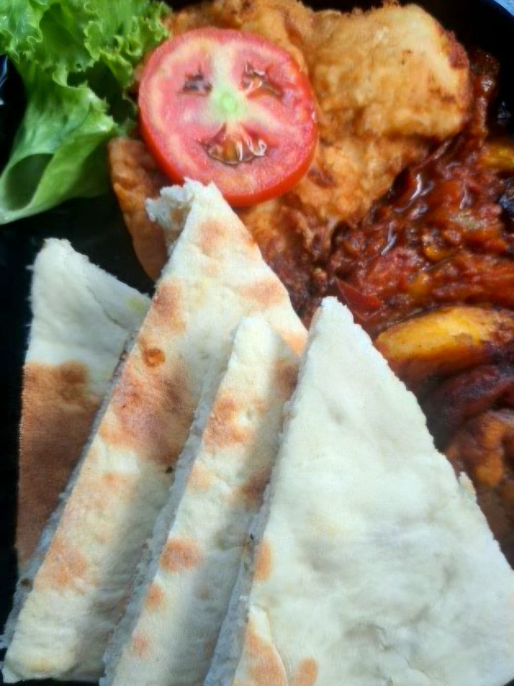 Roast bake with sautéed saltfish, tomato and lettuce
